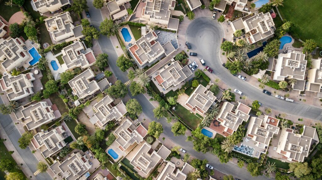 Aerial view of Saakaar Aqua City, a top township in Patna, showcasing modern apartments, wide internal roads, green open spaces, and gated community infrastructure surrounded by developing urban areas near Patna.