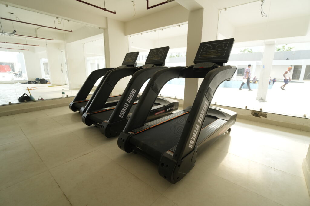 Luxury gym with modern treadmills at Aqua City Patna offering panoramic views